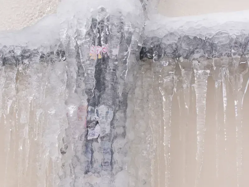 Thick ice built up on a structure after a hard freeze, the kind of cold that splits pipes